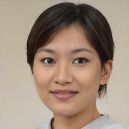 Joyful asian young-adult female with medium  brown hair and brown eyes