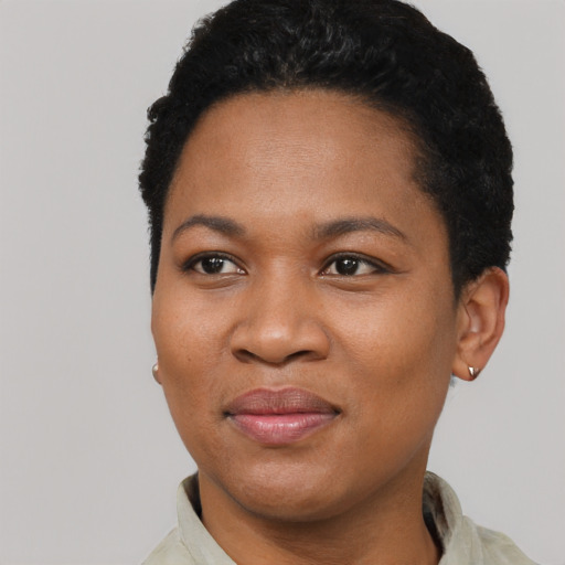 Joyful black young-adult female with short  black hair and brown eyes