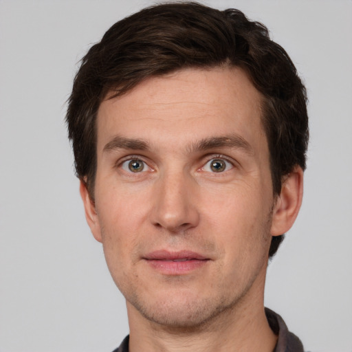 Joyful white adult male with short  brown hair and grey eyes