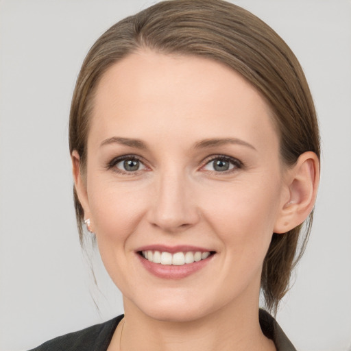 Joyful white young-adult female with medium  brown hair and blue eyes