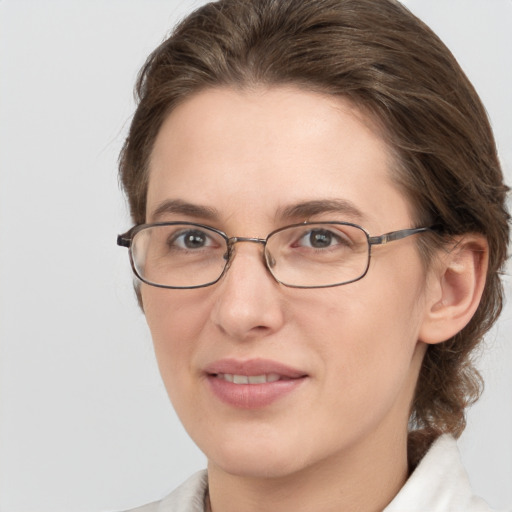 Joyful white adult female with medium  brown hair and grey eyes