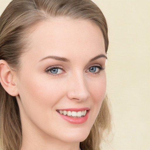 Joyful white young-adult female with long  brown hair and blue eyes