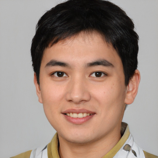 Joyful asian young-adult male with short  brown hair and brown eyes