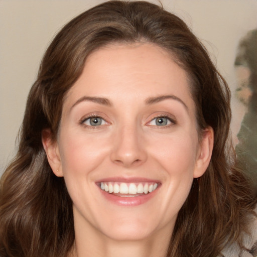 Joyful white young-adult female with medium  brown hair and green eyes