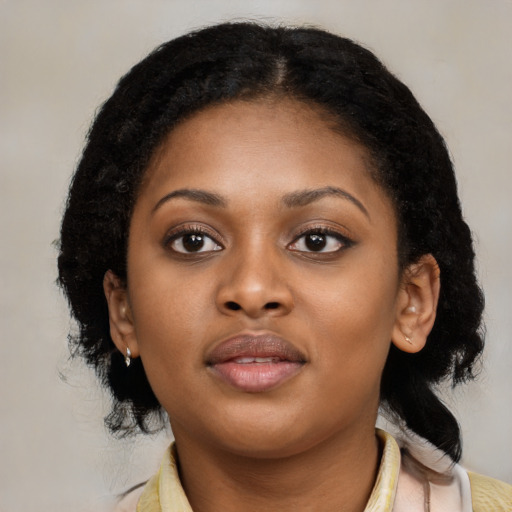 Joyful black young-adult female with medium  black hair and brown eyes
