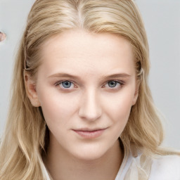 Joyful white young-adult female with long  brown hair and blue eyes