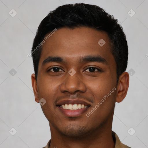 Joyful black young-adult male with short  black hair and brown eyes