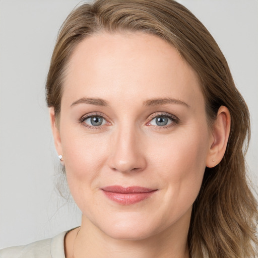 Joyful white young-adult female with long  brown hair and blue eyes