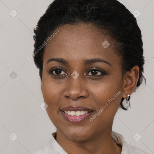 Joyful black young-adult female with short  black hair and brown eyes