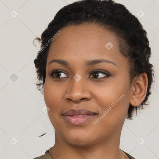 Joyful black young-adult female with short  brown hair and brown eyes