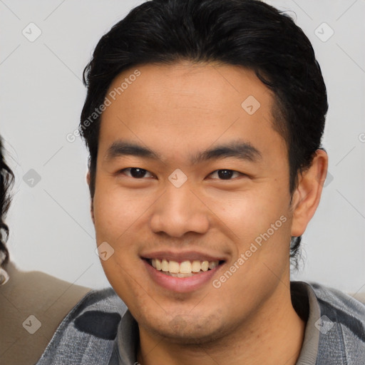 Joyful asian young-adult male with short  brown hair and brown eyes