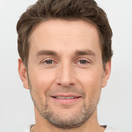 Joyful white adult male with short  brown hair and brown eyes