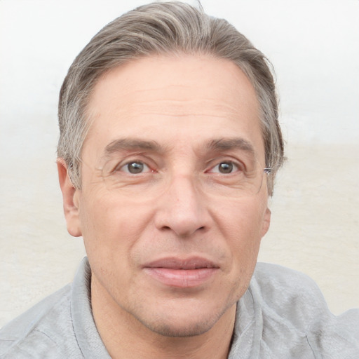 Joyful white adult male with short  brown hair and grey eyes