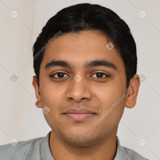 Joyful latino young-adult male with short  black hair and brown eyes