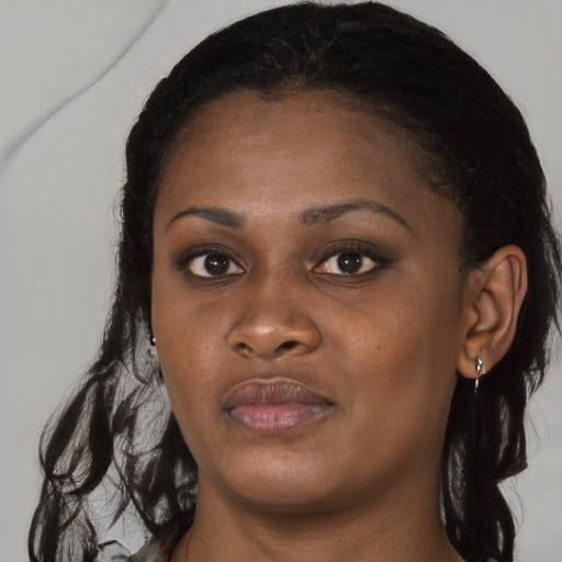 Joyful black young-adult female with long  black hair and brown eyes