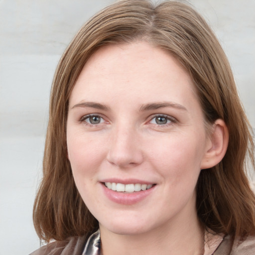 Joyful white young-adult female with medium  brown hair and blue eyes