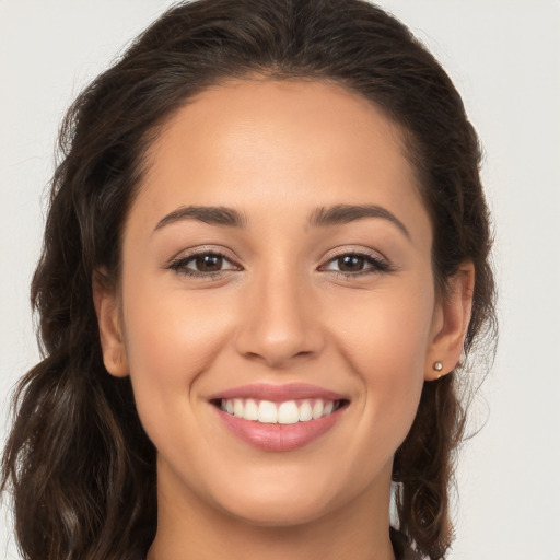 Joyful white young-adult female with long  brown hair and brown eyes