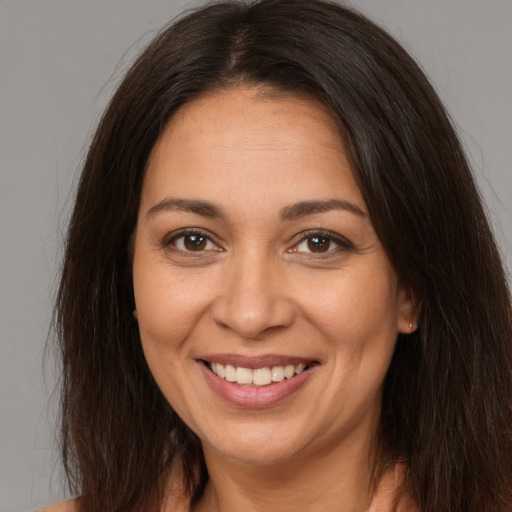 Joyful white young-adult female with long  brown hair and brown eyes