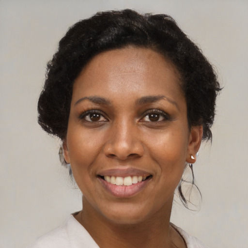 Joyful black young-adult female with medium  black hair and brown eyes