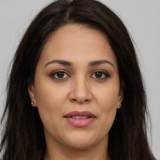 Joyful white young-adult female with long  brown hair and brown eyes
