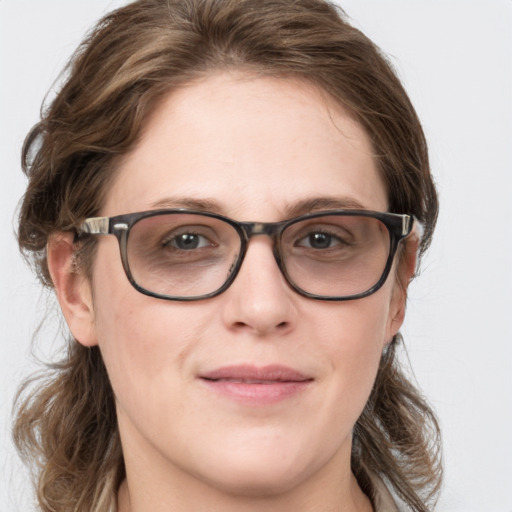 Joyful white young-adult female with medium  brown hair and blue eyes