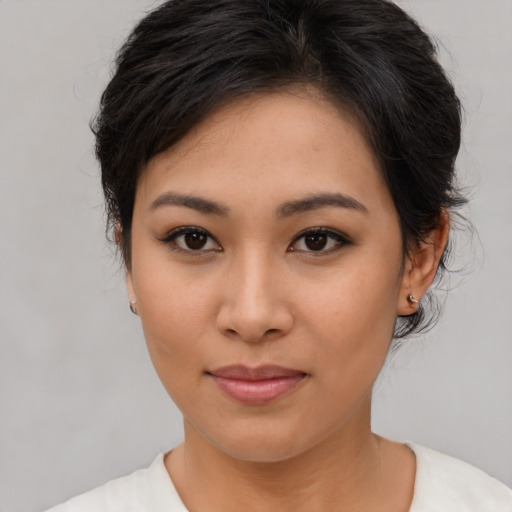 Joyful asian young-adult female with medium  brown hair and brown eyes