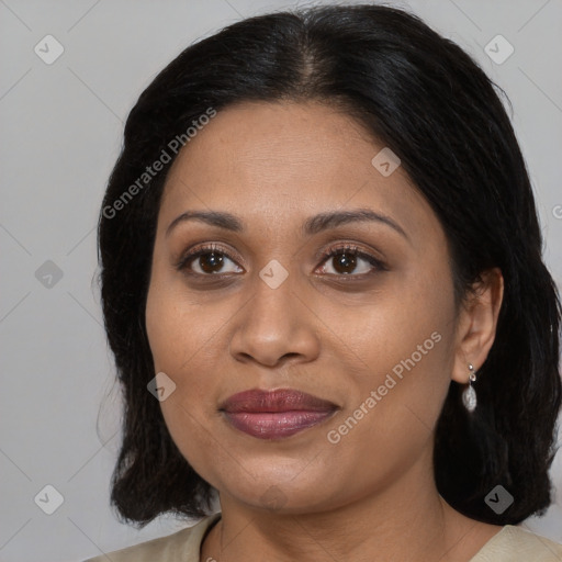 Joyful latino adult female with medium  brown hair and brown eyes