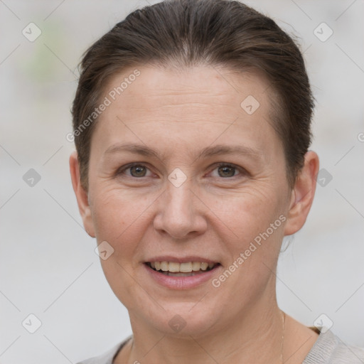 Joyful white adult female with short  brown hair and grey eyes