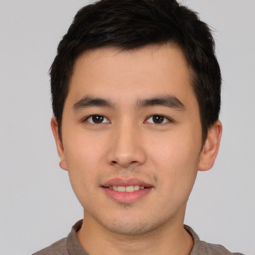 Joyful asian young-adult male with short  brown hair and brown eyes