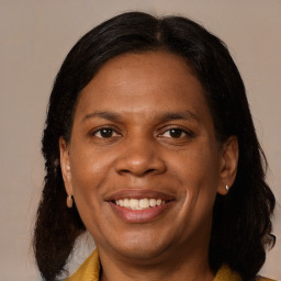 Joyful black adult female with medium  brown hair and brown eyes