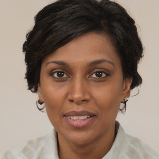 Joyful black young-adult female with medium  brown hair and brown eyes