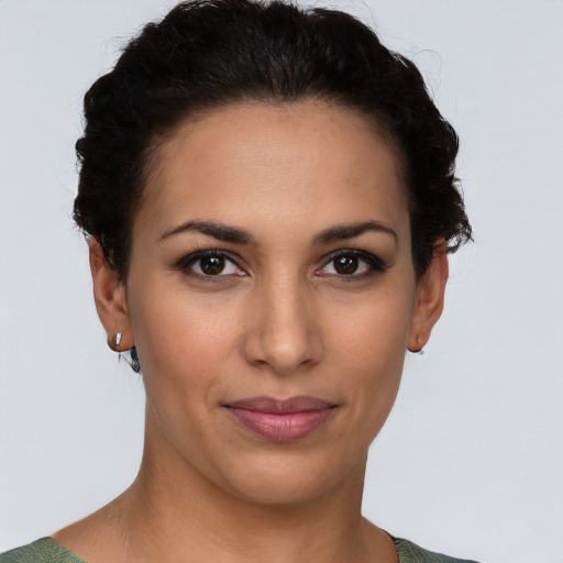 Joyful latino young-adult female with short  brown hair and brown eyes