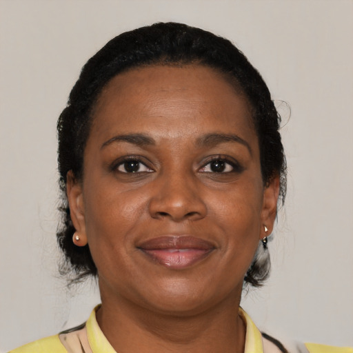 Joyful black adult female with short  brown hair and brown eyes