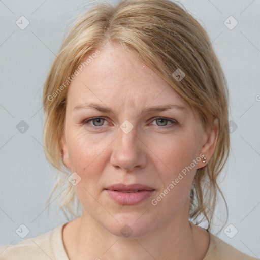 Joyful white adult female with medium  brown hair and blue eyes