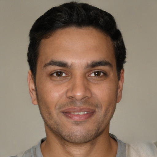 Joyful white young-adult male with short  black hair and brown eyes
