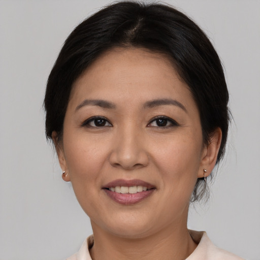 Joyful asian young-adult female with medium  brown hair and brown eyes