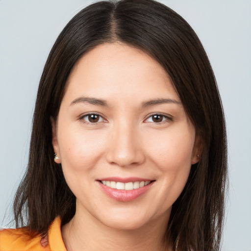 Joyful white young-adult female with long  brown hair and brown eyes