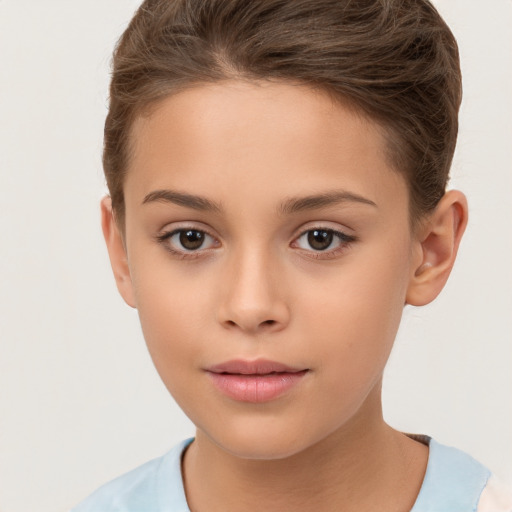 Joyful white child female with short  brown hair and brown eyes