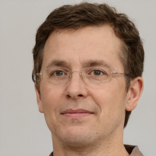 Joyful white adult male with short  brown hair and grey eyes