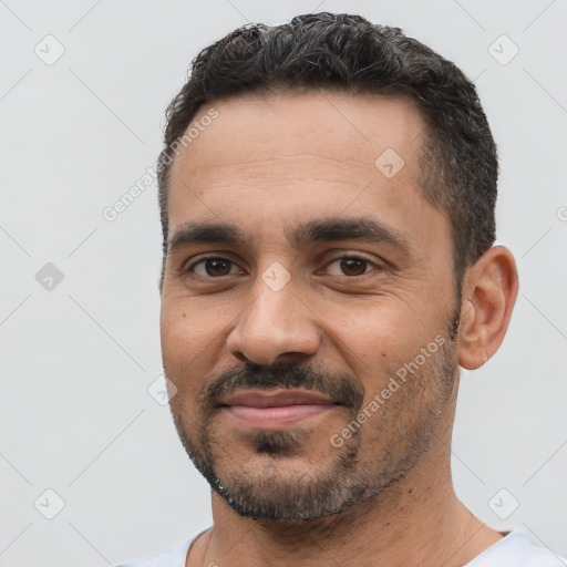Joyful white young-adult male with short  black hair and brown eyes