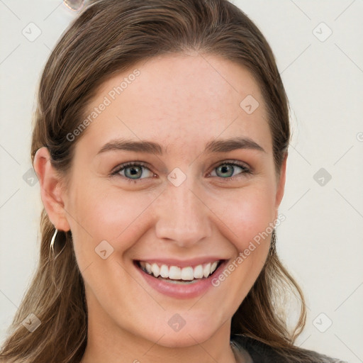 Joyful white young-adult female with long  brown hair and blue eyes