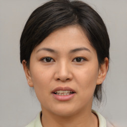 Joyful asian young-adult female with medium  brown hair and brown eyes