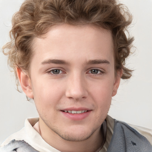 Joyful white young-adult male with short  brown hair and blue eyes