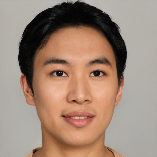 Joyful asian young-adult male with short  black hair and brown eyes