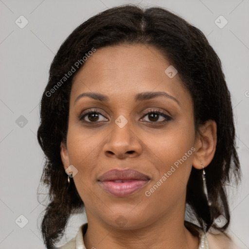 Joyful black adult female with medium  brown hair and brown eyes