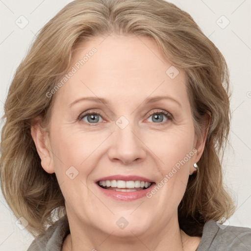 Joyful white adult female with medium  brown hair and blue eyes