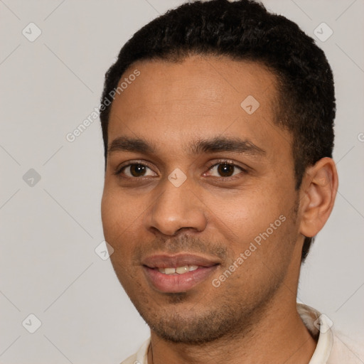 Joyful black young-adult male with short  black hair and brown eyes