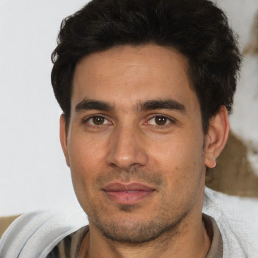 Joyful asian young-adult male with short  brown hair and brown eyes