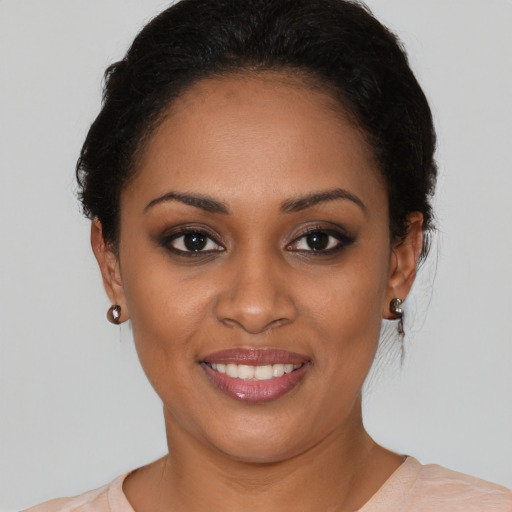 Joyful black young-adult female with short  brown hair and brown eyes