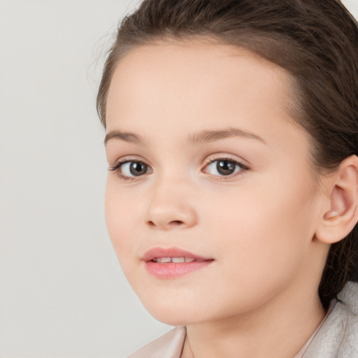 Joyful white child female with medium  brown hair and brown eyes